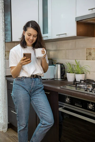Woman Drinking Morning Coffee Tea Kitchen Surfing Internet Phone Checking — Stock Photo, Image