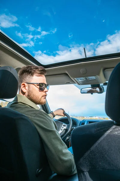 man portrait in car road trip travel concept