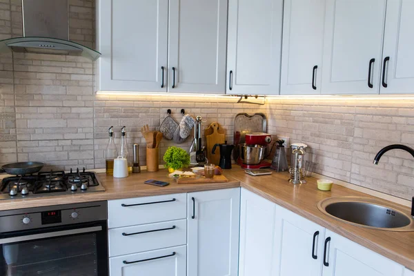 empty kitchen with sandwiches and coffee mug on the cooking top