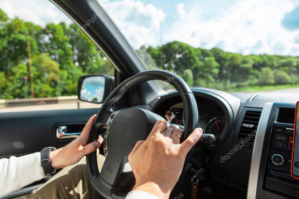 man hands on steering wheel cloudy sunny day copy space