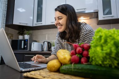 Kadınlar dizüstü bilgisayarda yemek tarifi kontrol ediyorlar. Kopya alanı