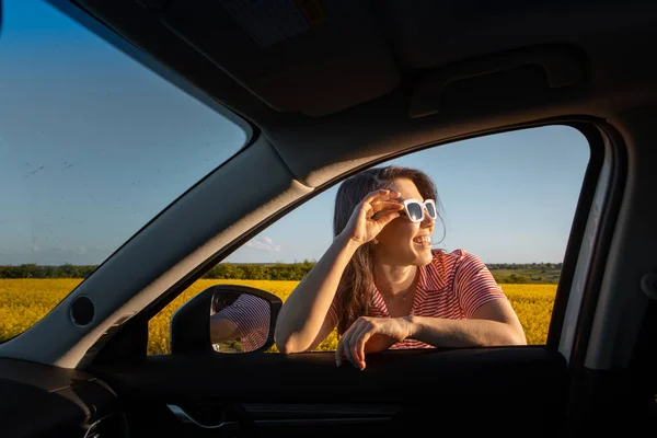 woman stop to enjoy sunset at road trip car travel