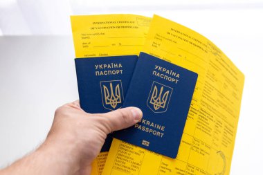 Covid aşı belgelerine sahip Ukrayna pasaportları elinde.