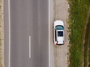 Yol kenarındaki fotokopi alanında park edilmiş arabanın üstten görünüşü