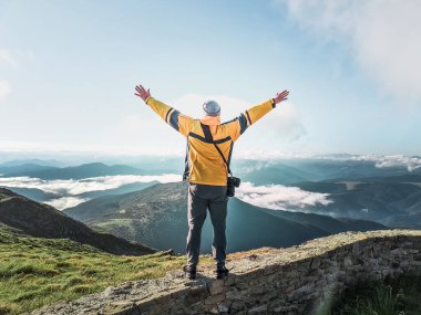 Dağların fotoğrafını çeken kameralı bir yürüyüşçü. Boşluğu kopyala