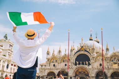 man holding italian fag in rise up hands venice central square san marco copy space