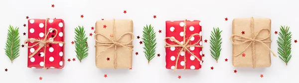 Christmas banner with red dotted and craft gifts, fir tree branches and red stars confetti. New year flatly.