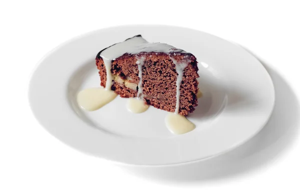 Cake chocolate with condensed milk on a white plate — Stock Photo, Image