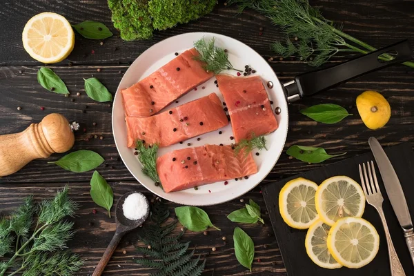 Salmon fillet on rustic kitchen table — Stock Photo, Image