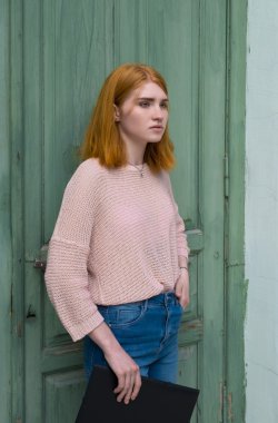 Kız elinde siyah bir klasörle ayakta