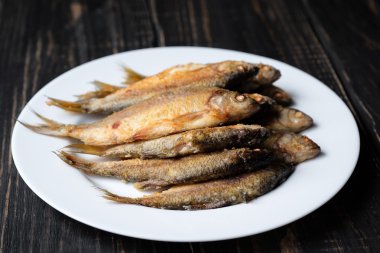 Beyaz tabakta kızarmış balık.