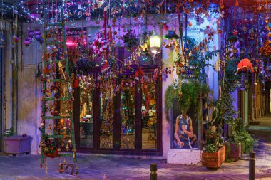 Yunanistan 'ın Selanik kentinde Noel, Yunan vitrininde vitrin dekore edildi. Covid-19 önlemleri nedeniyle kapalı olan boş bir mağazanın gece görüşü.