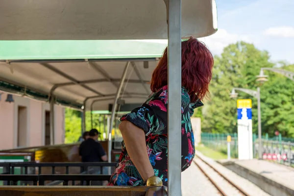 Tourist train with a woman with red hair showing