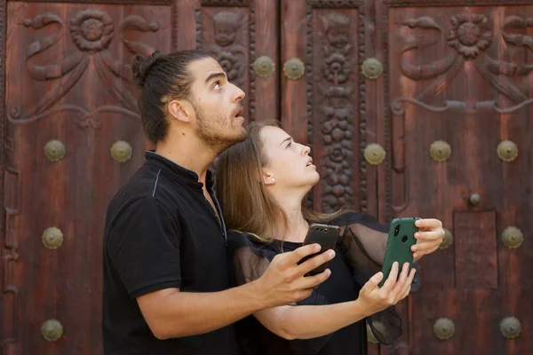 Genç çocuklar, güzergahı bulmak için akıllı telefondaki GPS haritasını kullanarak şehrin yolunu şaşırdılar.