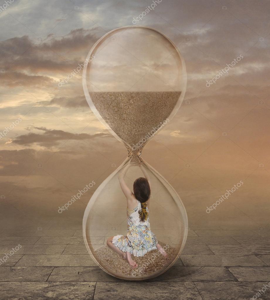 There is a girl into a hourglass. Stock Photo by Iridi 112145820