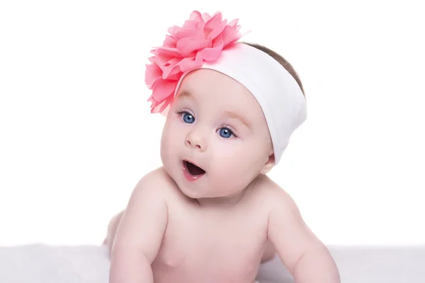 Portrait of cute little baby girl with pink bow flower on her he — Stock Photo, Image