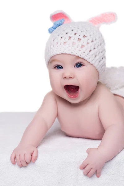 Funny baby in white knitted hat with ears bunny crying — Stock Photo, Image