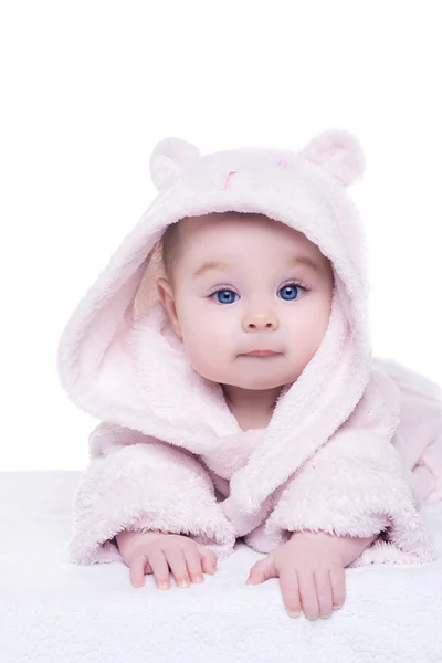 Little baby girl in pink bathrobe lying on her belly — Stock Photo, Image