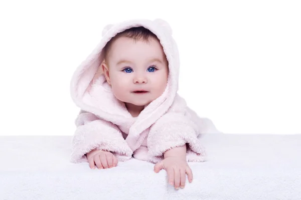 Cute baby child in pink bathrobe lying down on blanket — Stock Photo, Image