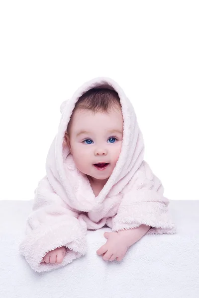 Cute baby child in pink bathrobe lying down on blanket — Stock Photo, Image