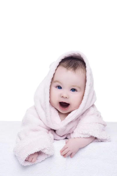 Baby girl with blue eyes in pink bathrobe lying on her belly — Stock Photo, Image