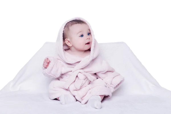 Cute baby sitting on a chair in a pink bathrobe — Stock Photo, Image