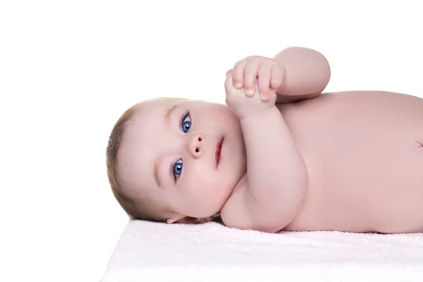 Adorable baby with blue eyes lying on back — Stock Photo, Image