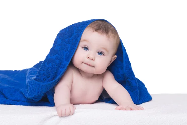 Mavi havlu/boş altında kamera bakarak büyük mavi gözlü bebek