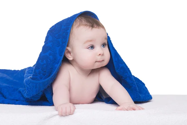 Baby with big blue eyes under blue towel/blanket — Stock Photo, Image
