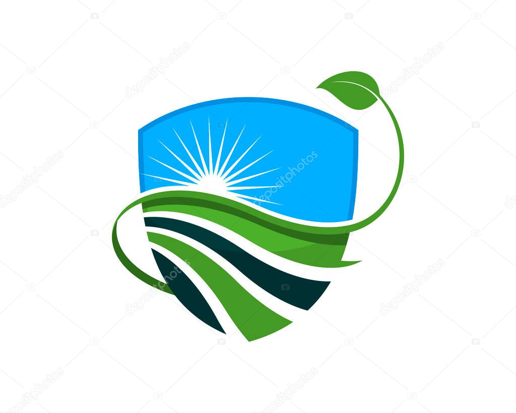 Shield with farm field and nature leaf