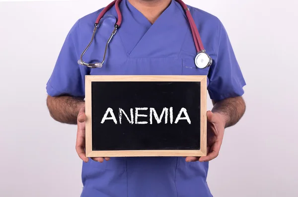 Doctor holding mini blackboard — Stock Photo, Image