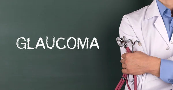 Doctor standing in front of blackboard — Stock Photo, Image