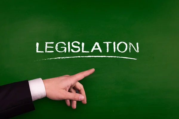 Businessman pointing on legislation — Stock Photo, Image