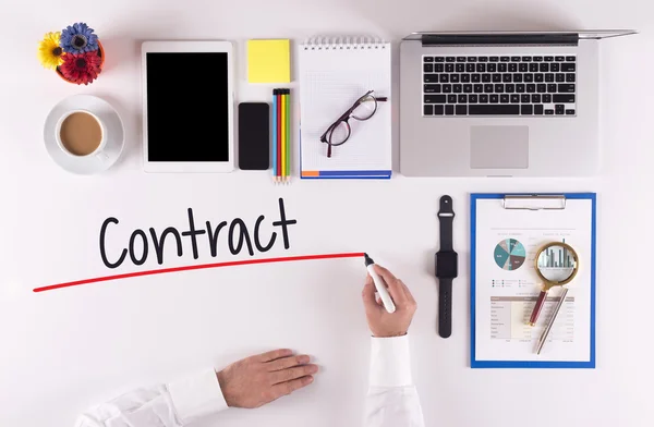 Businessman writing with marker on desk — Stock Photo, Image