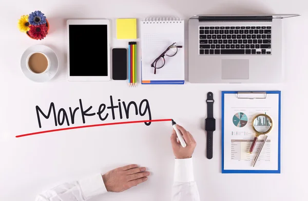 Businessman writing with marker on desk — Stock Photo, Image