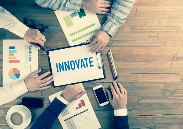 Business team sitting on table — Stock Photo, Image