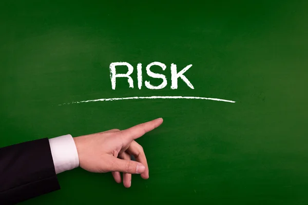 Businessman pointing on risk — Stock Photo, Image