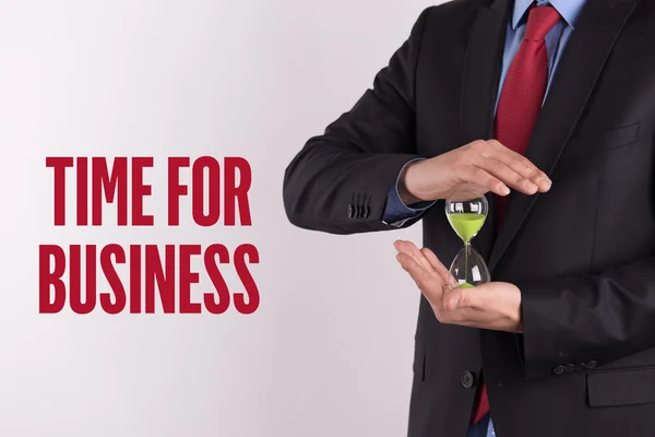 Businessman holding hourglass — Stock Photo, Image