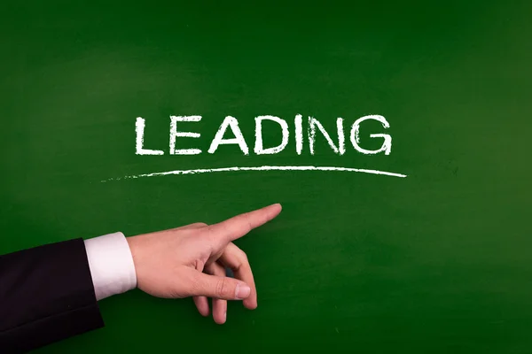 Businessman pointing on leading — Stock Photo, Image