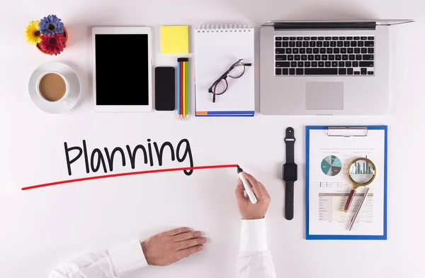 Businessman writing with marker on desk — Stock Photo, Image