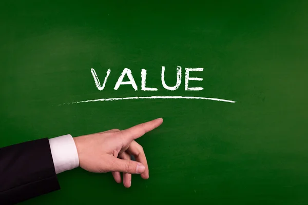 Businessman pointing on value — Stock Photo, Image