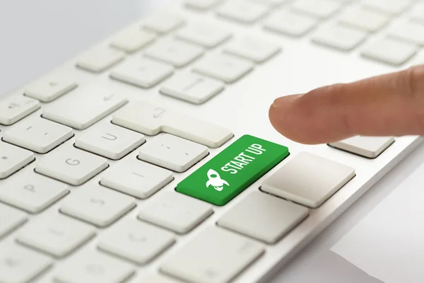 Палец нажимает кнопку зеленой клавиатуры — стоковое фото