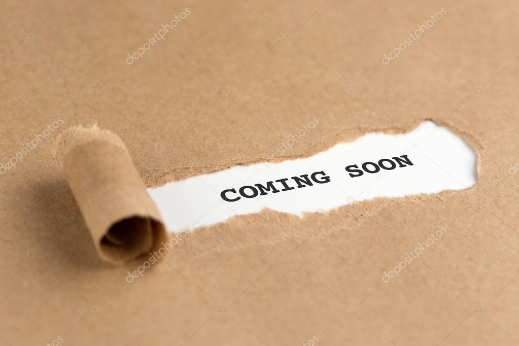 Torn brown paper with coming soon text on it