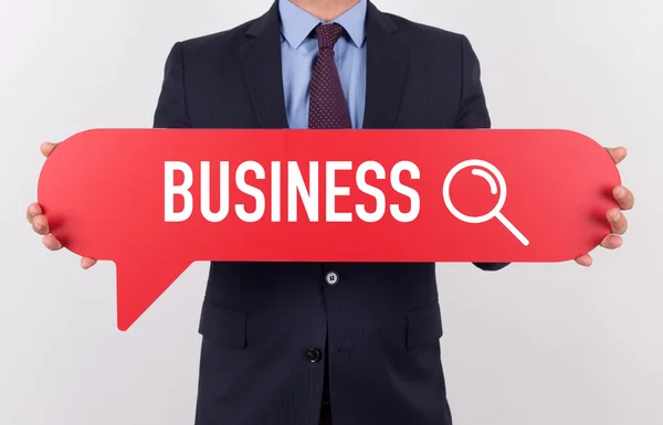 Businessman holding speech bubble — Stock Photo, Image