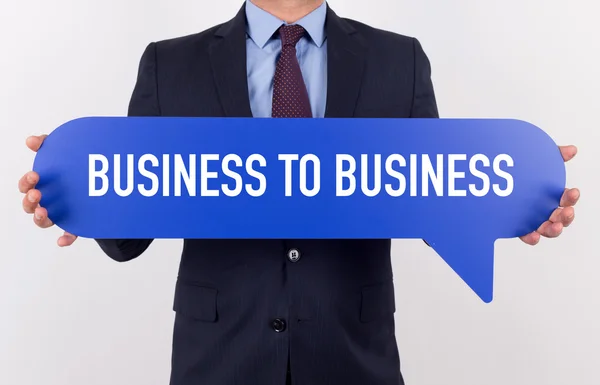 Businessman holding speech bubble — Stock Photo, Image
