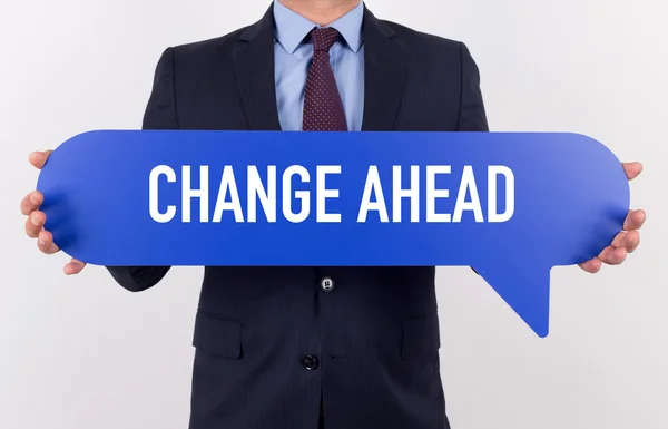 Businessman holding speech bubble — Stock Photo, Image