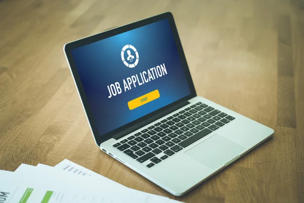 Laptop on desk with icon on screen — Stock Photo, Image