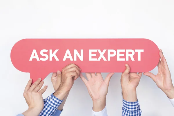 Group of people holding speech bubble — Stock Photo, Image