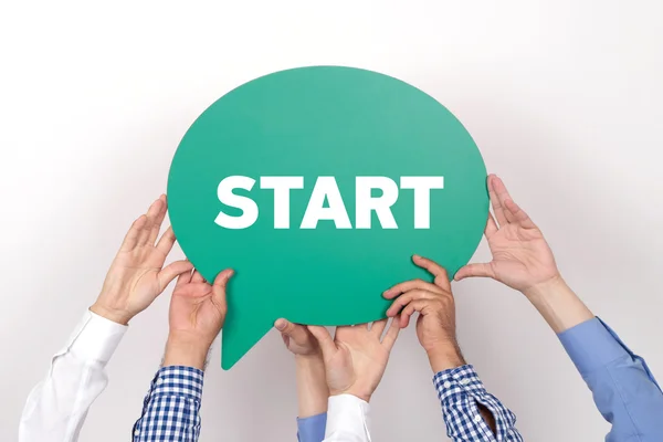 Group of people holding speech bubble — Stock Photo, Image