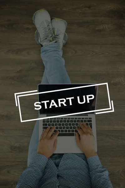 Young man sitting on floor with laptop — Stock Photo, Image